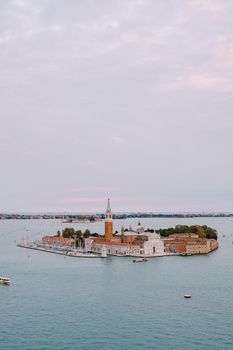 Aerial view from huge cathedral bell tower San Marco Campanile on San Giorgio Maggiore is one of most famous islands of the Venetian lagoon, in northern Italy.