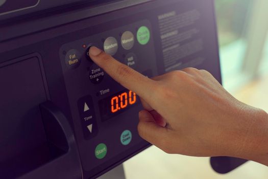 Close up hand women training on treadmill, doing cardio workout in gym.