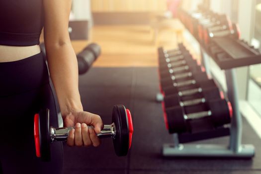 Young woman lifting weights on training class at gym. Concept fitness ,workout, gym exercise ,lifestyle and healthy.