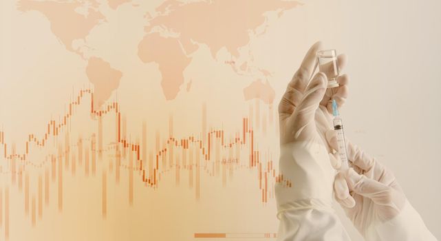 Doctor hand in white glove hold syringe with preparation jet from the needle with stock market graph and globe background.