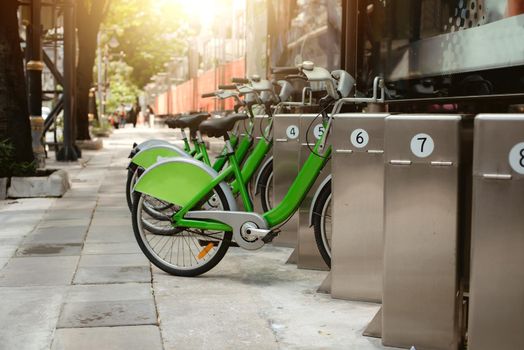 Green bicycle for rent in city / bike for rent.