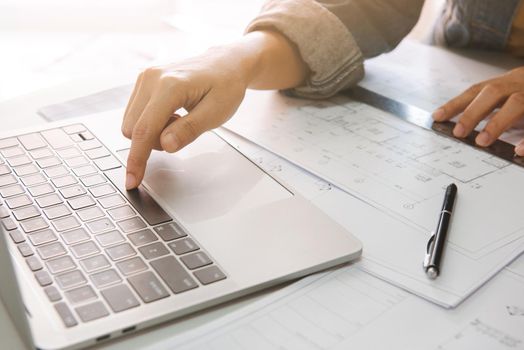 Close up of engineer or architect using laptop to planning project schedule., Engineering and construction concept.