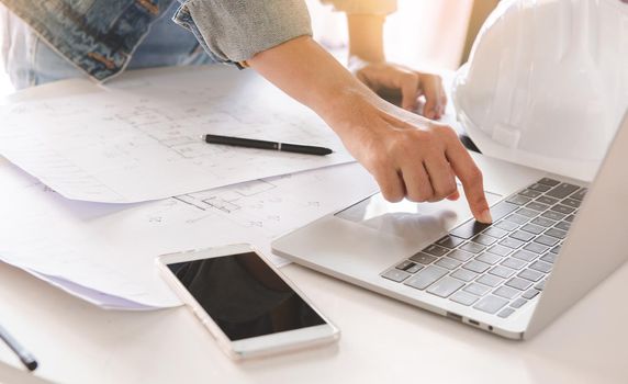 Top-View of engineers or architect using laptop to planning project schedule. Engineering and construction concept.