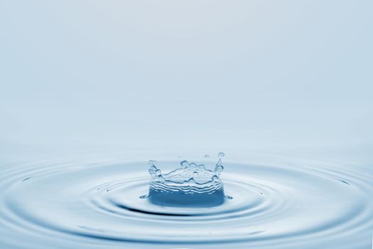 Water splash isolated on blue background.