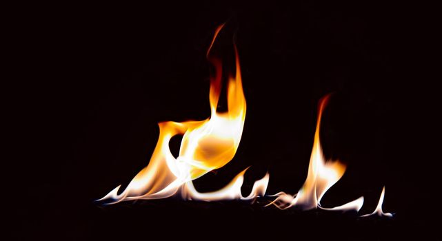 orange flame with reflection on a black background.