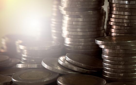 Close up of coins to stack of coins, Business Growth concept, There is money coins to stack of coins. Financial risk.