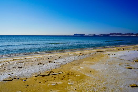 Seascape with a beach in snow.