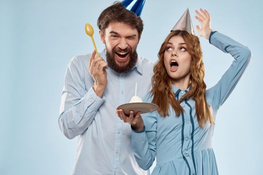 Party man and woman birthday cake corporate fun blue background. High quality photo