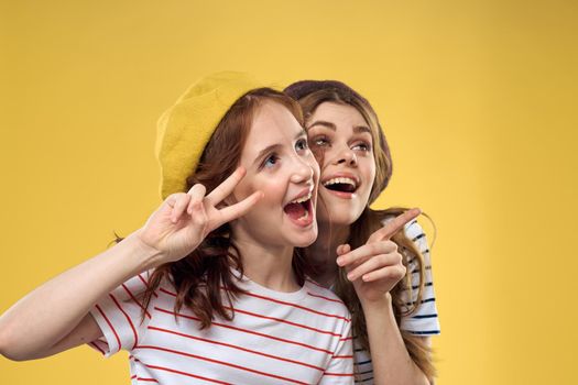 Mom and daughter embrace joy fun childhood lifestyle yellow background. High quality photo