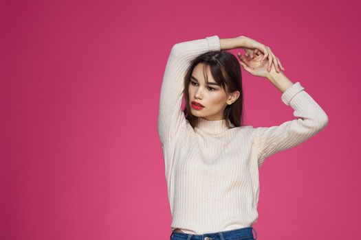 Beautiful brunette long hair fashionable clothes elegant style pink background. High quality photo