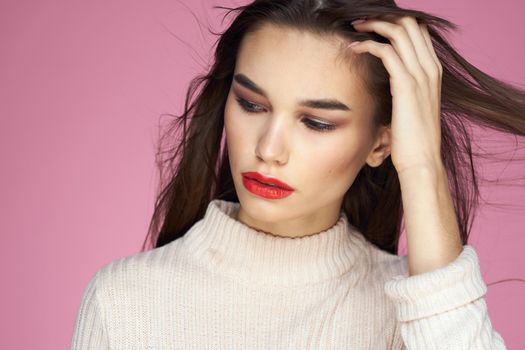 Beautiful brunette red lips white blouse close-up attractive view pink background. High quality photo