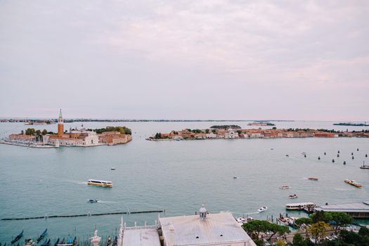 Aerial view from huge cathedral bell tower San Marco Campanile, on The main pier of gondolas, near Piazza San Marco and San Giorgio Maggiore is one of most famous islands of Venetian lagoon