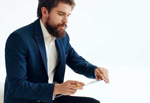 businessman in suit with documents on knees on light background cropped view. High quality photo