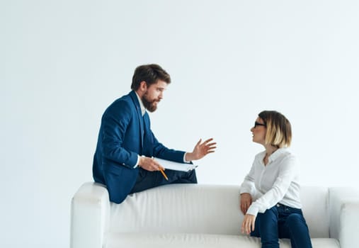 Work colleagues sit on the couch communicating lifestyle interior emotions. High quality photo