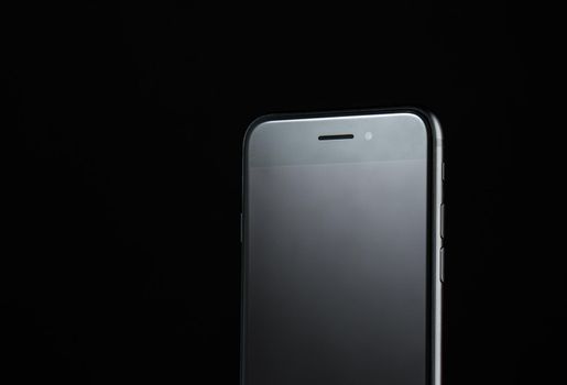 touchscreen mobile phone on black background new technologies without buttons. High quality photo