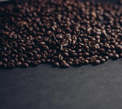 aromatic coffee beans on a dark background closeup close-up. High quality photo