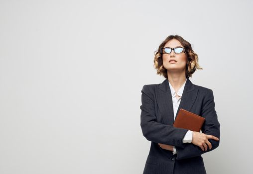 woman in classic suit documents book glasses finance business. High quality photo