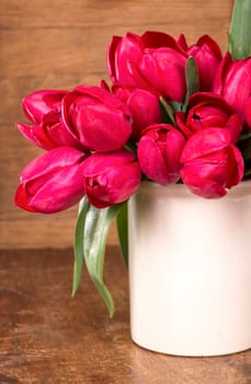 Fresh pink tulips on the wooden background