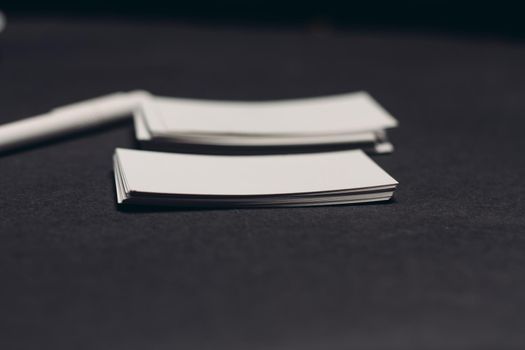 business cards on dark table and pen office mockup. High quality photo