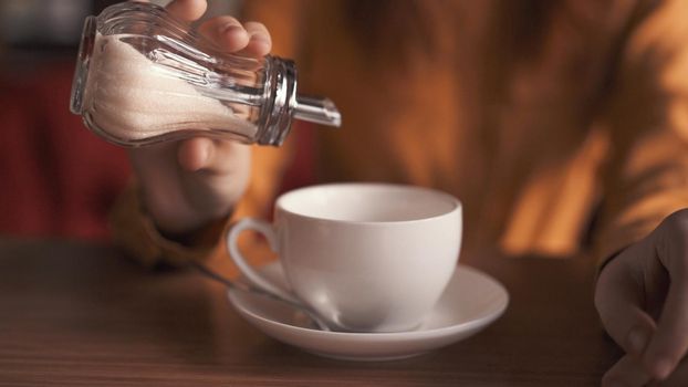 mug with a drink adding sugar cafe rest. High quality photo