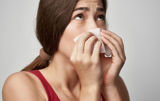 sick woman in red t shirt health problems cold handkerchief. High quality photo