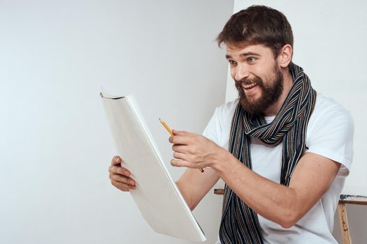 Man in white t-shirt artist drawing creativity work. High quality photo