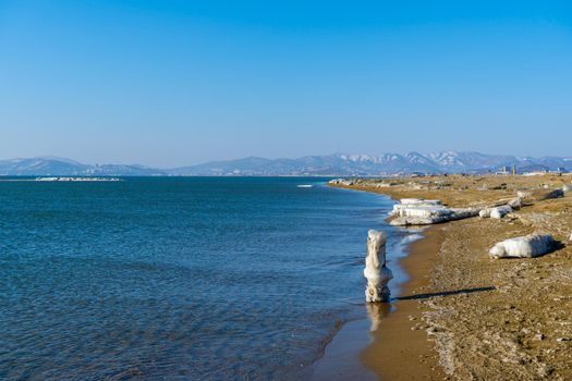 Marine landscape with views of the beach of the Bay of Nakhodka in the winter. Primorsky Krai, Russia