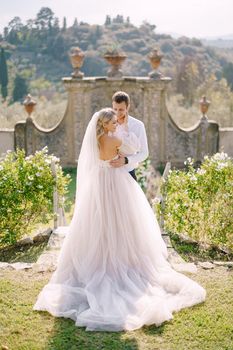 Wedding couple in the garden at sunset. Wedding in Florence, Italy, in an old villa-winery.