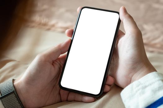 Cropped shot of professional woman holding blank screen smartphone in bedroom at home.