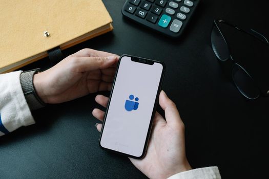 CHIANG MAI,THAILAND - APR 06, 2020 : A working from home employee is downloading the Microsoft Teams social platform, ready for remote working in isolation from home