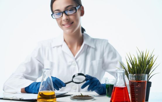 woman with plant in soil research laboratory gloves doctor. High quality photo