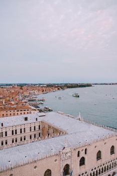 The ferry pier and mooring place for gondolas - San Marco-San Zaccaria, Venice, Italy. Aerial view from huge cathedral bell tower Saint Mark Campanile.