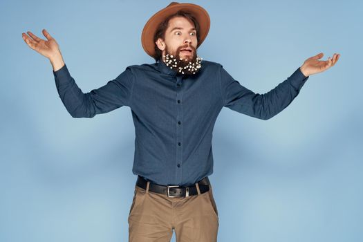 Man in hat emotions joy flowers Studio shirt fashionable clothes. High quality photo