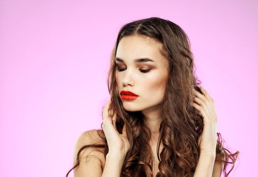 Sexy woman model with red lips brunette model and pink background. High quality photo