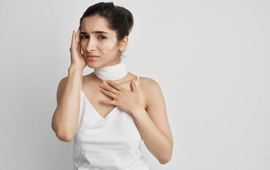 woman in white t-shirt bandaged neck health problems. High quality photo