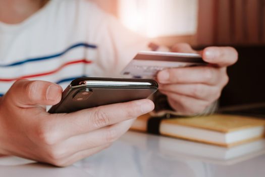 Online payment, Woman's hands holding a credit card and using smart phone for online shopping