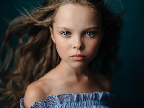 Adorable beautiful baby girl on a dark background close-up portrait cropped view. High quality photo