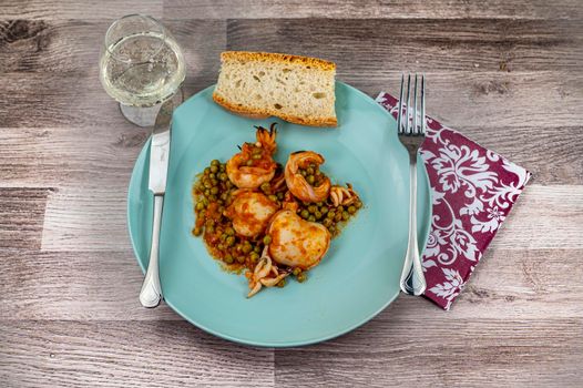 flat composition cuttlefish and peas with glass of wine cutlery and bread