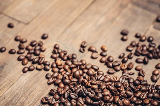 coffee beans scattered wood background morning aroma beverage preparation. High quality photo