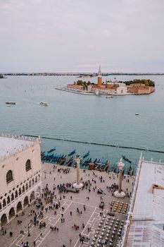 Aerial view, from huge cathedral bell tower San Marco Campanile, on The main pier of gondolas near Piazza San Marco and San Giorgio Maggiore is one of most famous islands of Venetian lagoon