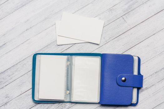 business card holder with forms on a wooden table top view close-up. High quality photo