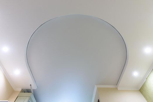 Horseshoe-shaped two-level suspended ceiling, the lower level is made of plasterboard, the upper level is stretched from PVC