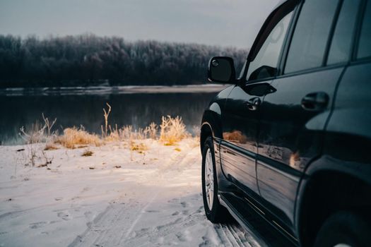 black car nature river winter trip travel landscape. High quality photo