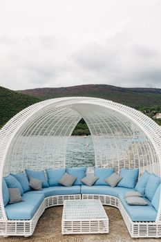 White wicker sofa by the sea, for 8 people, table and visor