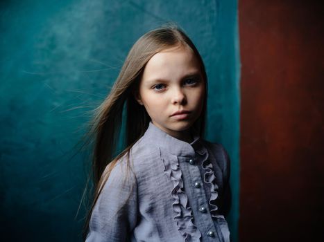 Portrait of a beautiful girl in a gray sundress on a turquoise background close-up model. High quality photo
