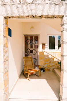 A wooden rocking chair at the entrance to a house in Croatia, Split