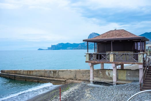 Seascape with a view of the Sudak embankment. Crimea