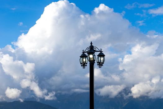 electric torch against a mountain landscape and clouds