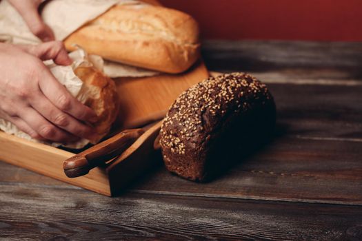 flour products rye bread on a tray and a sharp knife on the table. High quality photo