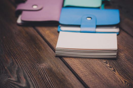 bright business card holders on a wooden background texture of a pack of white paper. High quality photo